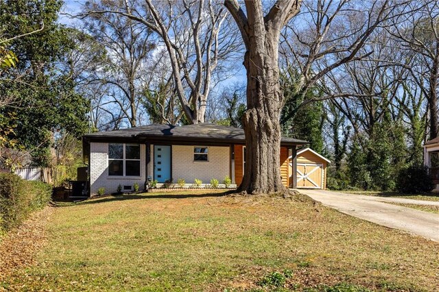 single story home with brick siding and a front lawn