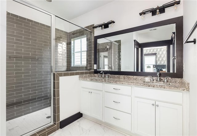 bathroom with a shower with door and vanity