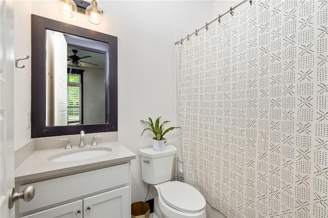 bathroom with ceiling fan, curtained shower, vanity, and toilet