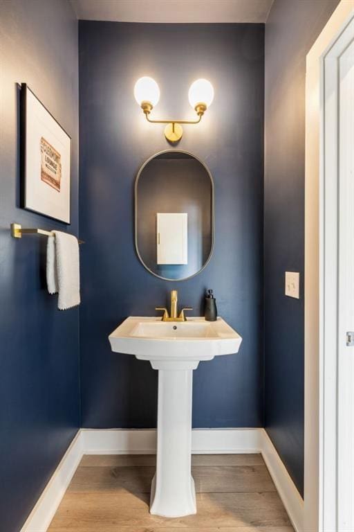 bathroom with wood finished floors and baseboards