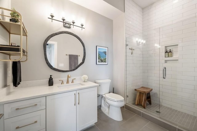 bathroom featuring tile patterned flooring, vanity, an enclosed shower, and toilet