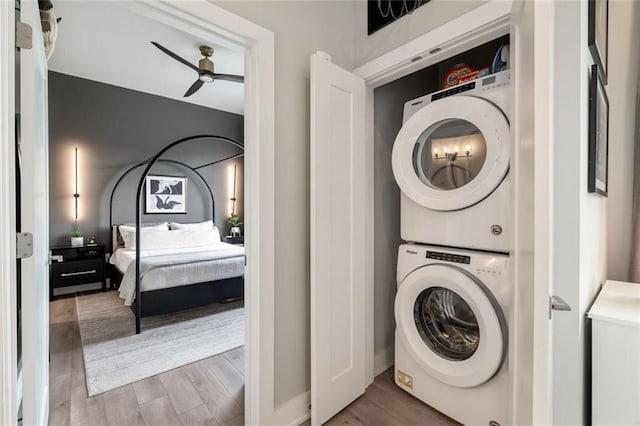 22 Airline St NE Unit 403, Atlanta, GA 30312 - laundry room featuring stacked washing machine and dryer, a ceiling fan, and wood finished floors