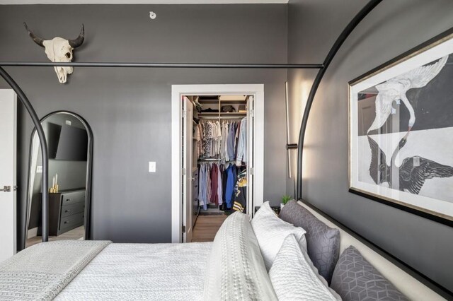 bedroom featuring a walk in closet and a closet