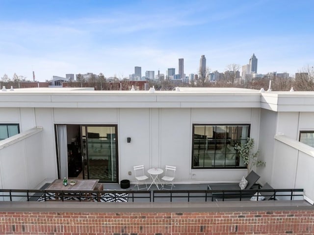 rear view of property featuring a view of city and brick siding