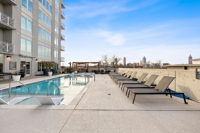 community pool with a patio and a pergola