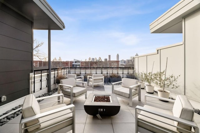 view of patio / terrace featuring an outdoor living space with a fire pit