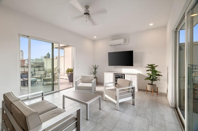 living area with a ceiling fan, a wall mounted AC, recessed lighting, wine cooler, and baseboards