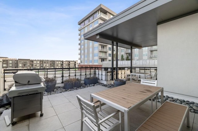 view of patio featuring grilling area and a balcony