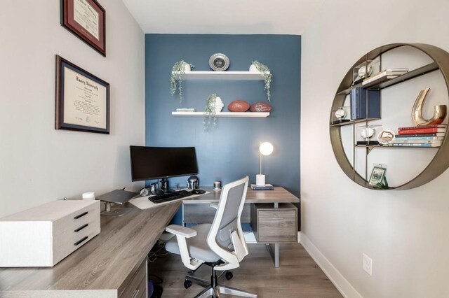 office featuring baseboards and wood finished floors