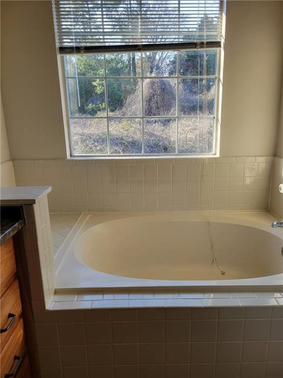 full bathroom with vanity and a garden tub