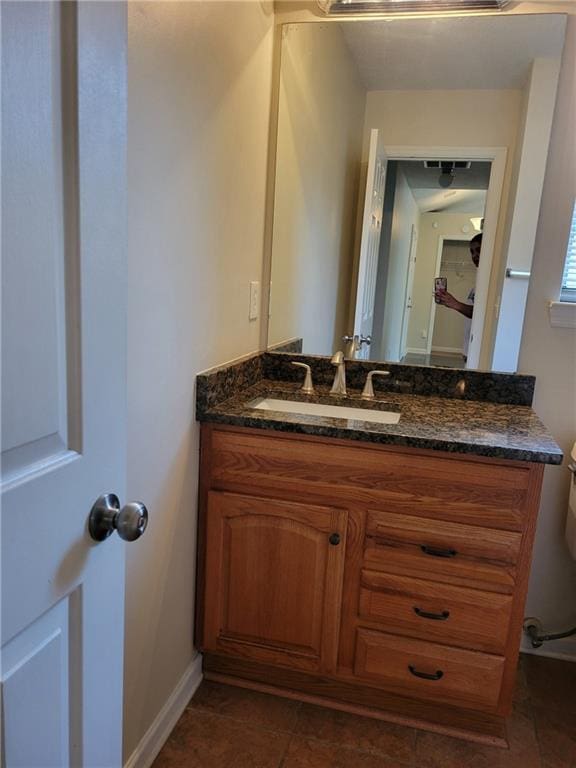 bathroom with tile patterned floors, vanity, and baseboards