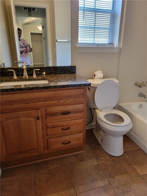 bathroom featuring vanity, bathing tub / shower combination, toilet, and visible vents