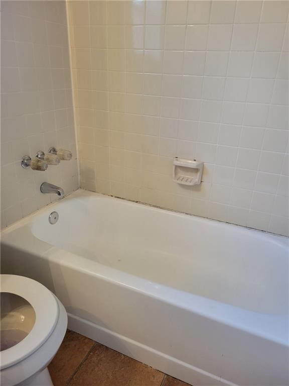 full bath featuring toilet and tile patterned flooring