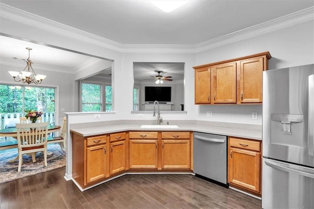 kitchen with a sink, stainless steel appliances, light countertops, and dark wood-type flooring