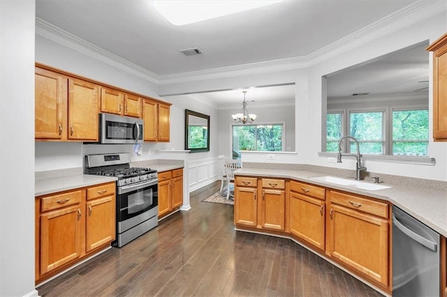 kitchen with light countertops, stainless steel appliances, visible vents, and a sink