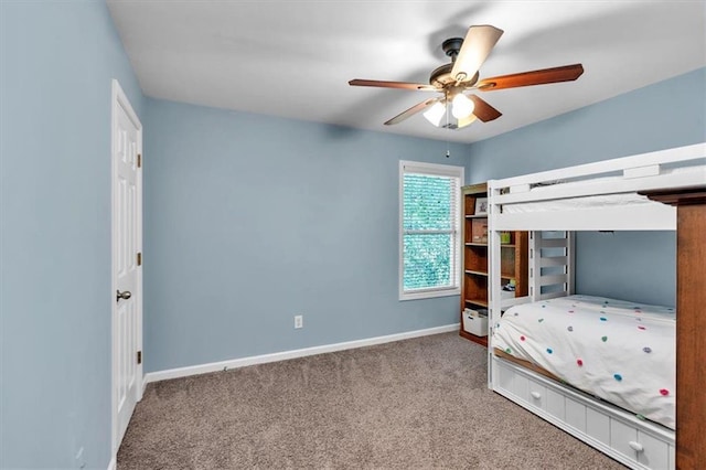 carpeted bedroom with baseboards and a ceiling fan
