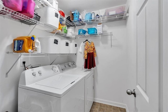 washroom with laundry area, baseboards, and separate washer and dryer