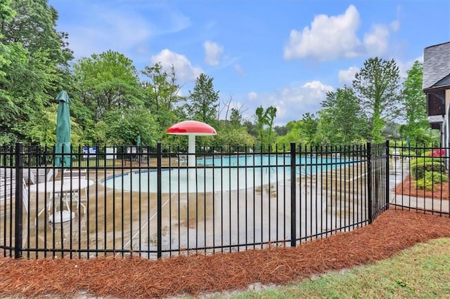 view of gate featuring a community pool and fence
