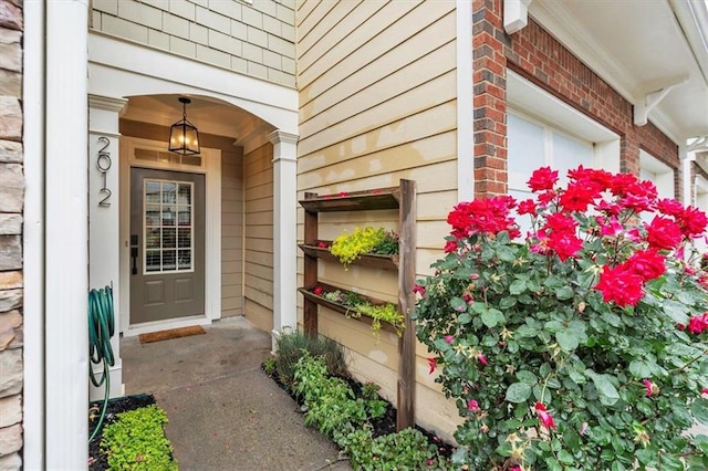 entrance to property featuring brick siding