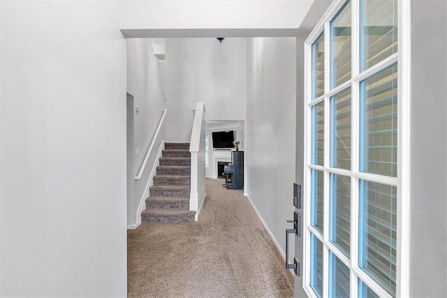 interior space with stairway, baseboards, and carpet floors