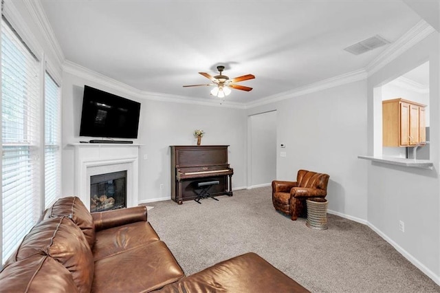 living room featuring a ceiling fan, crown molding, carpet flooring, and visible vents