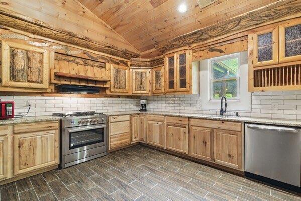 230 Old Mill White Ext, Jasper, GA 30143 - kitchen with stainless steel appliances, vaulted ceiling, wood ceiling, backsplash, and light brown cabinets