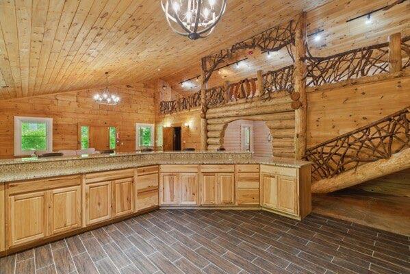 230 Old Mill White Ext, Jasper, GA 30143 - kitchen featuring a chandelier, wood ceiling, lofted ceiling, light countertops, and light brown cabinetry