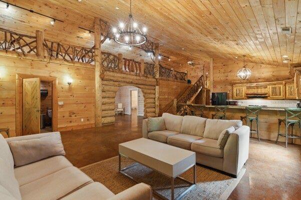 230 Old Mill White Ext, Jasper, GA 30143 - living area with wood ceiling, arched walkways, a chandelier, rustic walls, and concrete flooring