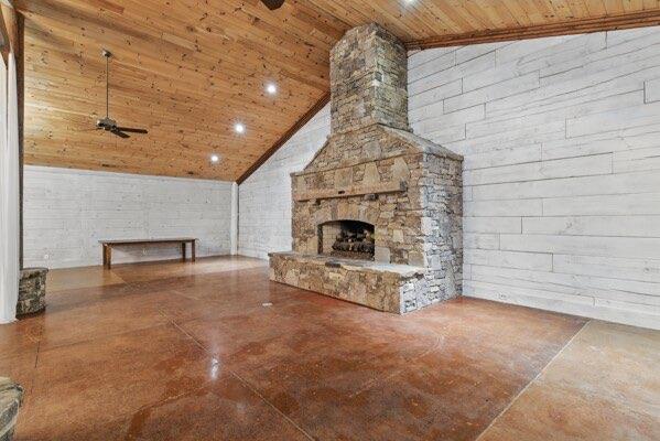 230 Old Mill White Ext, Jasper, GA 30143 - unfurnished living room with wooden ceiling, high vaulted ceiling, a ceiling fan, concrete floors, and a stone fireplace