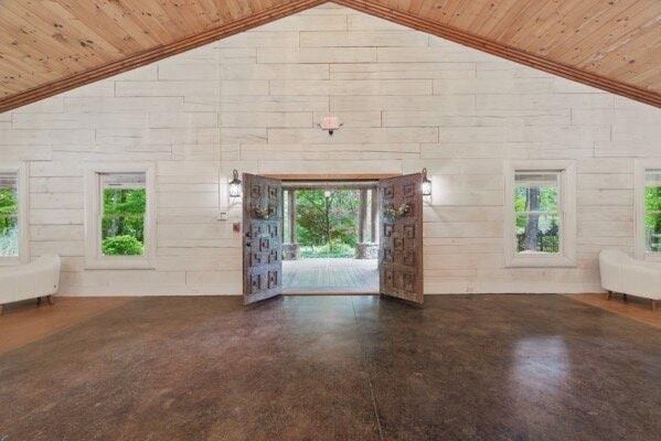230 Old Mill White Ext, Jasper, GA 30143 - unfurnished living room with wooden ceiling, healthy amount of natural light, high vaulted ceiling, and wood walls