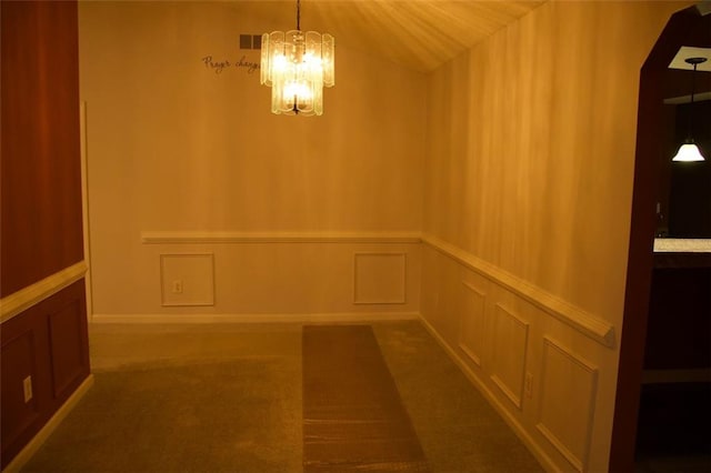 interior space featuring carpet flooring and a notable chandelier