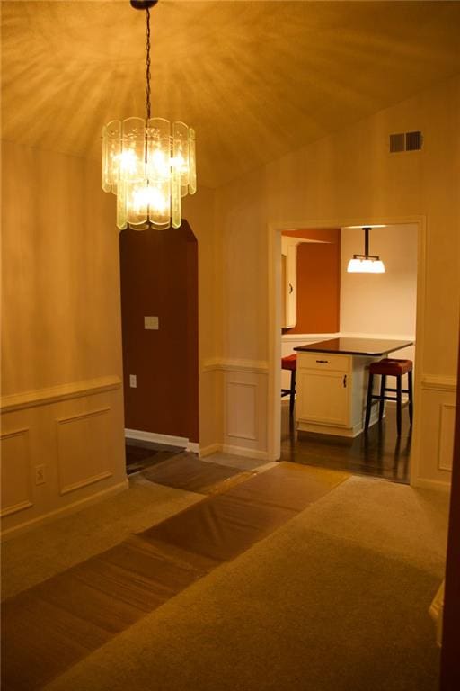 interior space with an inviting chandelier and vaulted ceiling