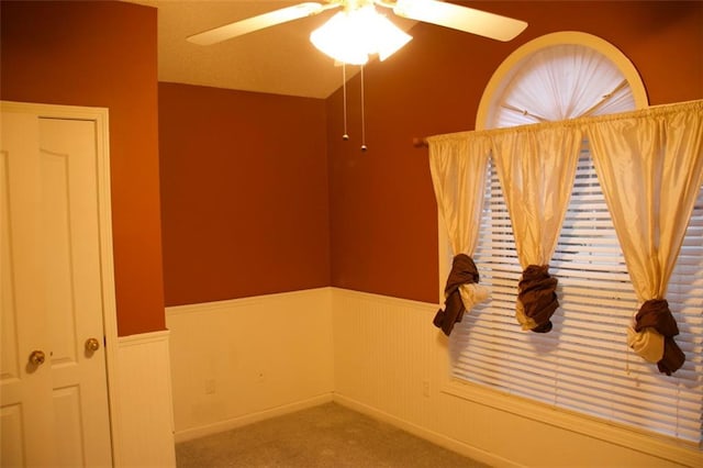 empty room with ceiling fan and carpet flooring