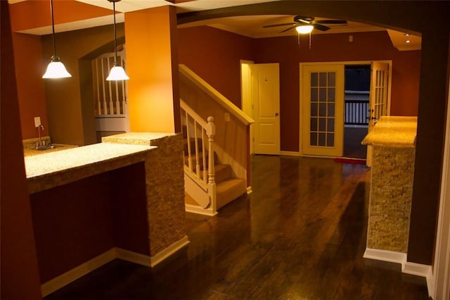 interior space featuring pendant lighting, ceiling fan, and dark hardwood / wood-style floors