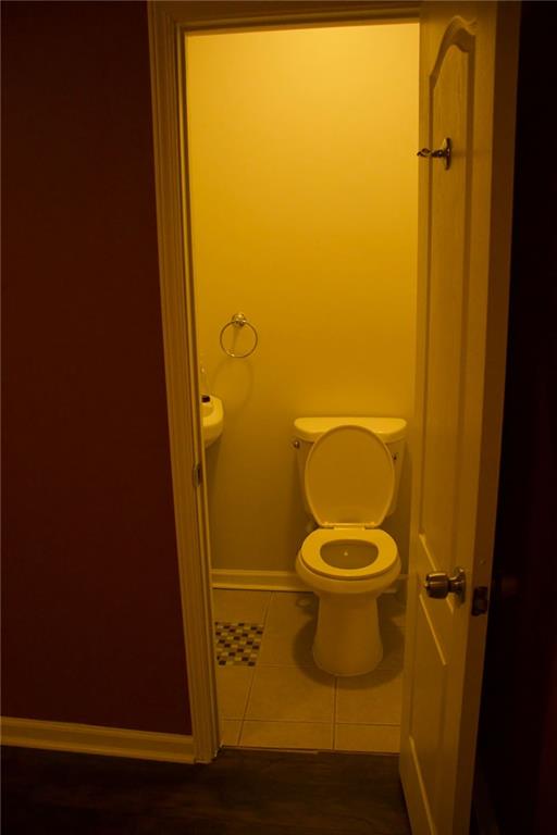 bathroom with tile patterned flooring and toilet