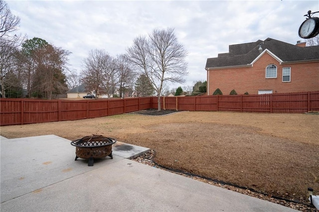 view of yard with a patio area and an outdoor fire pit