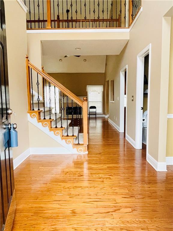 interior space featuring light hardwood / wood-style floors and a high ceiling