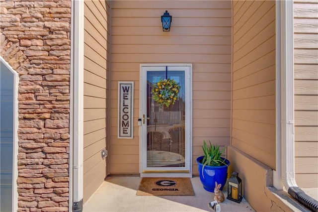 view of exterior entry featuring stone siding