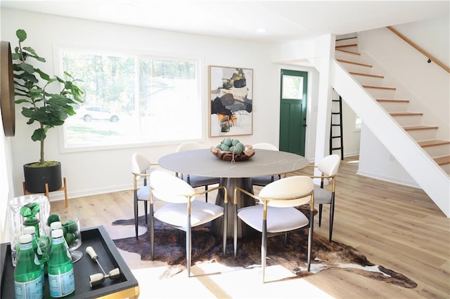 dining space with light hardwood / wood-style floors and plenty of natural light