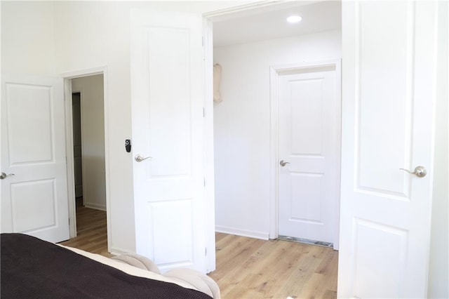 unfurnished bedroom featuring a closet and light hardwood / wood-style floors