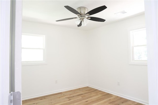 spare room with light hardwood / wood-style floors, plenty of natural light, and ceiling fan