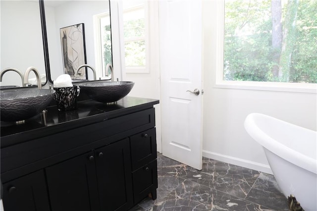 bathroom with vanity and a bathtub