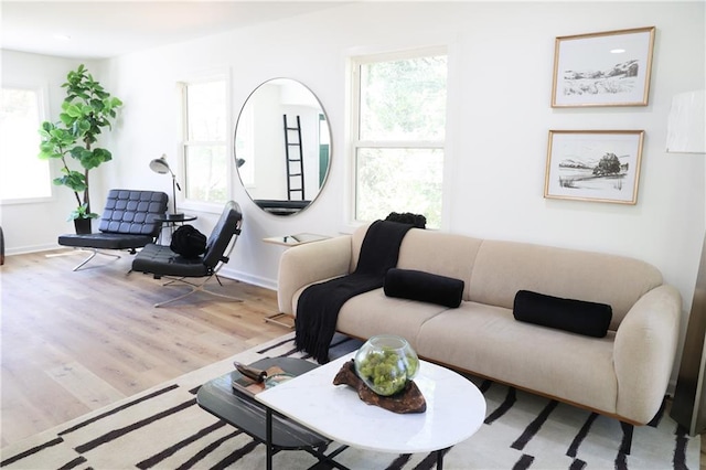 living room featuring light wood-type flooring and plenty of natural light