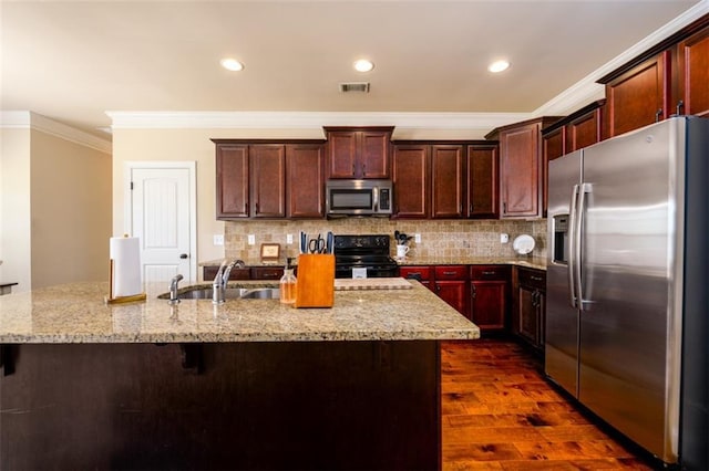 kitchen with a sink, tasteful backsplash, appliances with stainless steel finishes, and ornamental molding