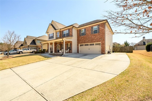 traditional-style house featuring driveway, brick siding, and a front lawn