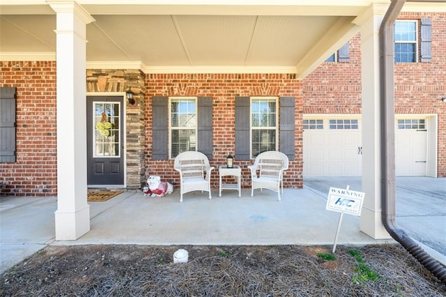 view of patio featuring covered porch and driveway