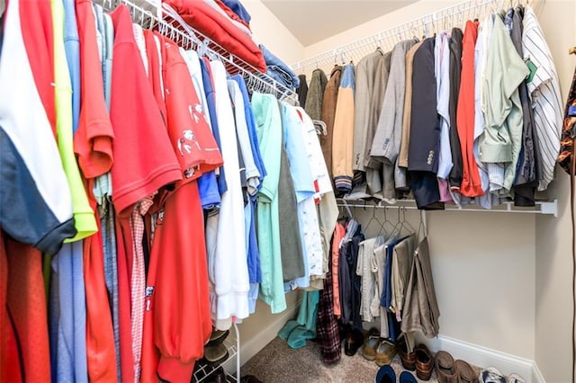 walk in closet featuring carpet floors