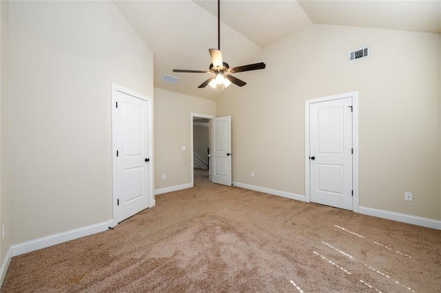 unfurnished bedroom with visible vents, high vaulted ceiling, and carpet floors