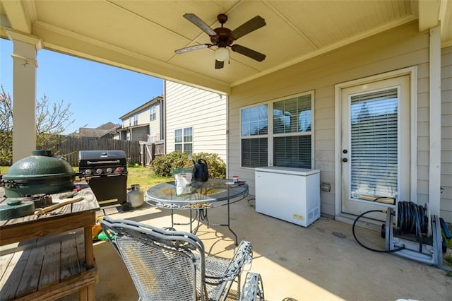 view of patio / terrace with grilling area, outdoor dining area, ceiling fan, and fence