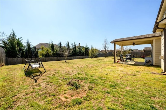 view of yard featuring ceiling fan, a patio, and a fenced backyard